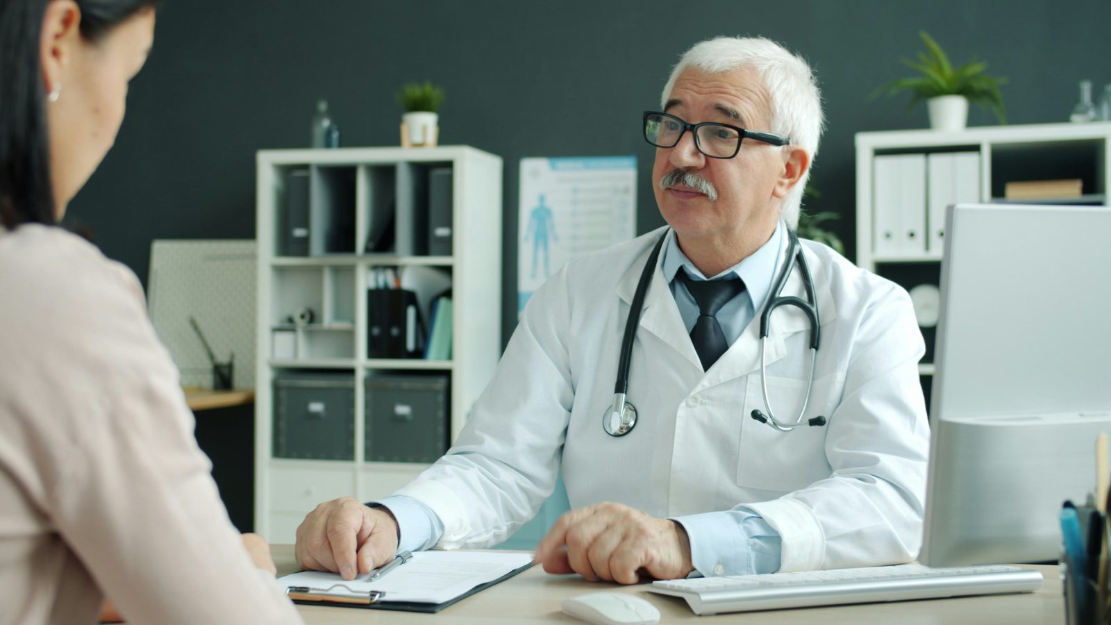 A geriatrician reviewing a care plan with a family member